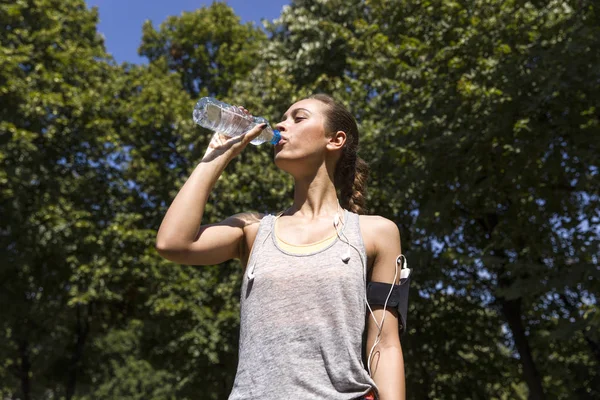 Genç ve güzel kadın içme suyu egzersiz sırasında