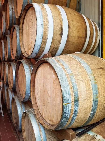 Wine barrels stacked  in the old cellar — Stock Photo, Image