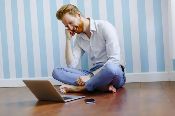 Man som sitter på golvet med laptop — Stockfoto