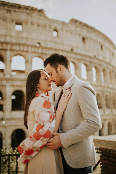 Loving couple visiting Italian famous landmarks Colosseum in Rom