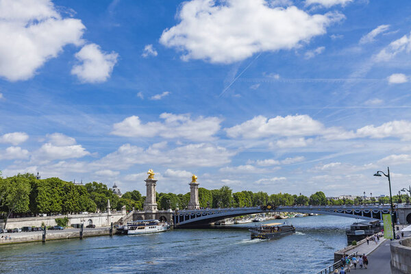 Tourist boat on river Seine by  Pont Alexandre III in Paris, Fra