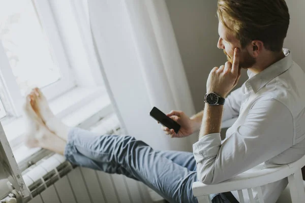 Stilig redhair man skriver ett meddelande på telefonen — Stockfoto