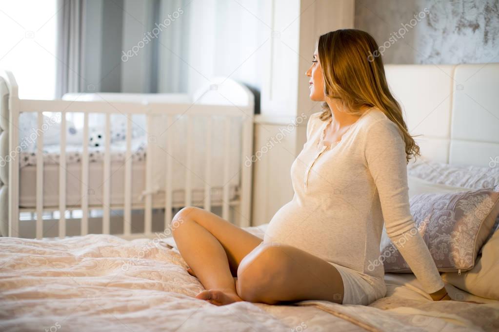 Pregnant woman on bed