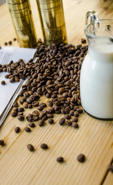 Coffee beans and milk in jar — Stock Photo, Image