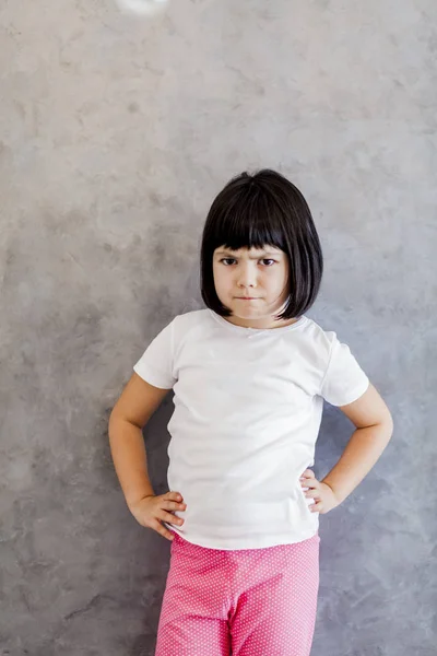 Frustriertes schwarzes Haar kleines Mädchen an der Wand — Stockfoto
