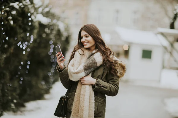 Young woman using phone in park