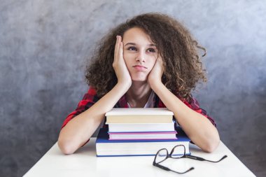 Kıvırcık saçlı genç kız diğerlerinden öğrenme kitapları