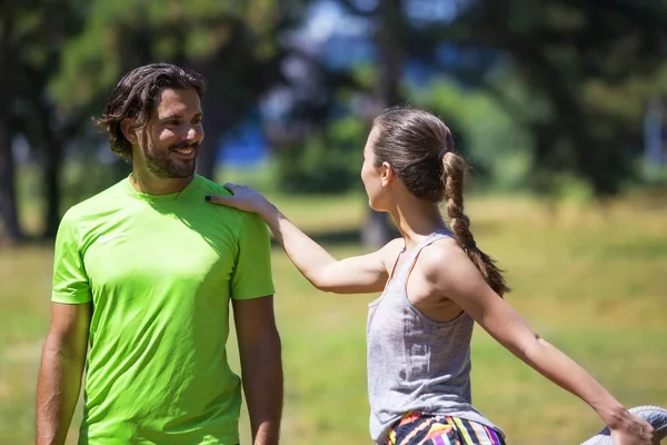 Sorridente coppia che si estende all'aperto — Foto Stock