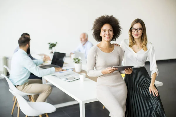 Two young businesswomen with a tablet in the office — Stock Photo, Image