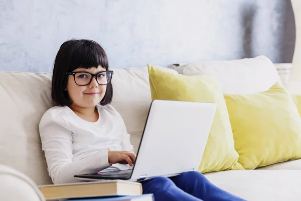 Niña con ropa casual usando un portátil — Foto de Stock