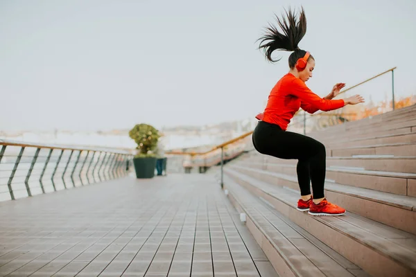 Jovem mulher se exercitando pulando fora — Fotografia de Stock