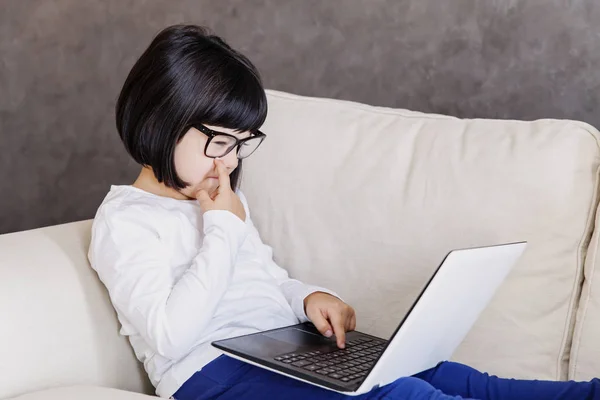 Niña con ropa casual usando un portátil — Foto de Stock