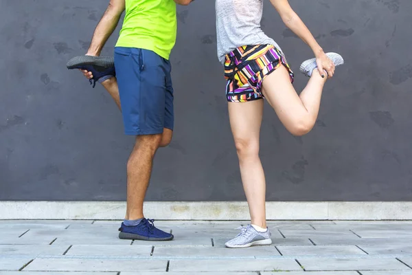 Attractive woman exercising with a personal trainer outside at s — Stock Photo, Image