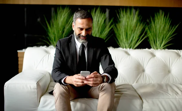 Бізнесмен середнього віку, що використовує мобільний телефон — стокове фото