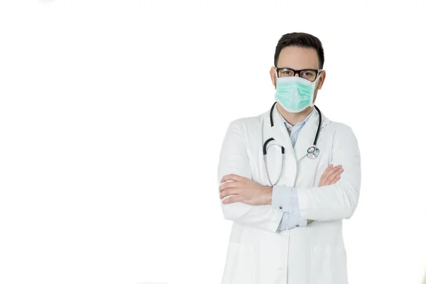 Handsome young doctor in white medical uniform and mask is looki — Stock Photo, Image