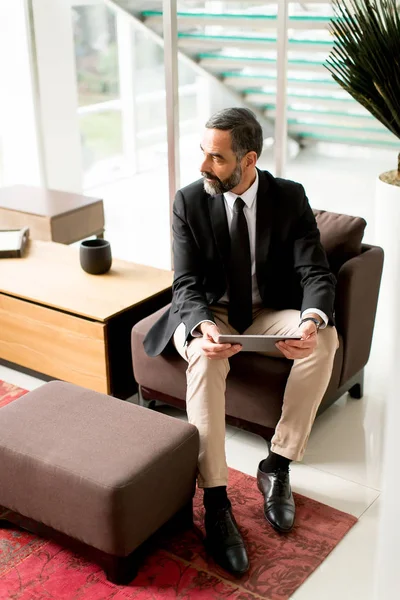 Confident senior businessman with digital tablet — Stock Photo, Image