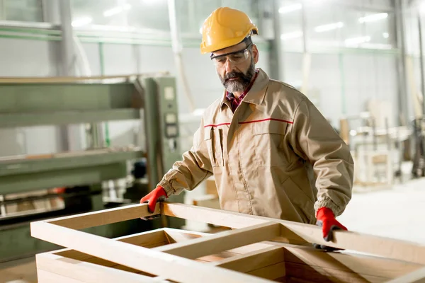 Middle aged worker working in the furniture factory — Stock Photo, Image