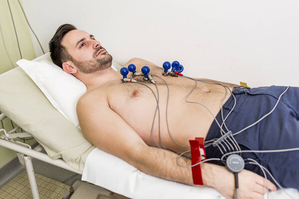 Young man doing EKG in hospital