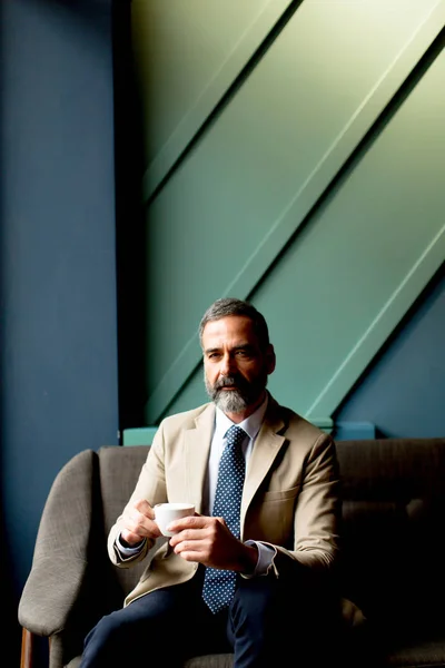 Handsome Mature Man Sitting Drinking Coffee — Stock Photo, Image