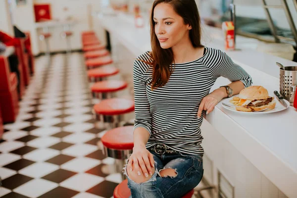 Mujer joven y bonita sentada en el restaurante — Foto de Stock