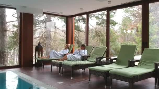 Pretty Young Women Relaxing Deckchairs Indoor Swimming Pool Winter Day — Stock Video