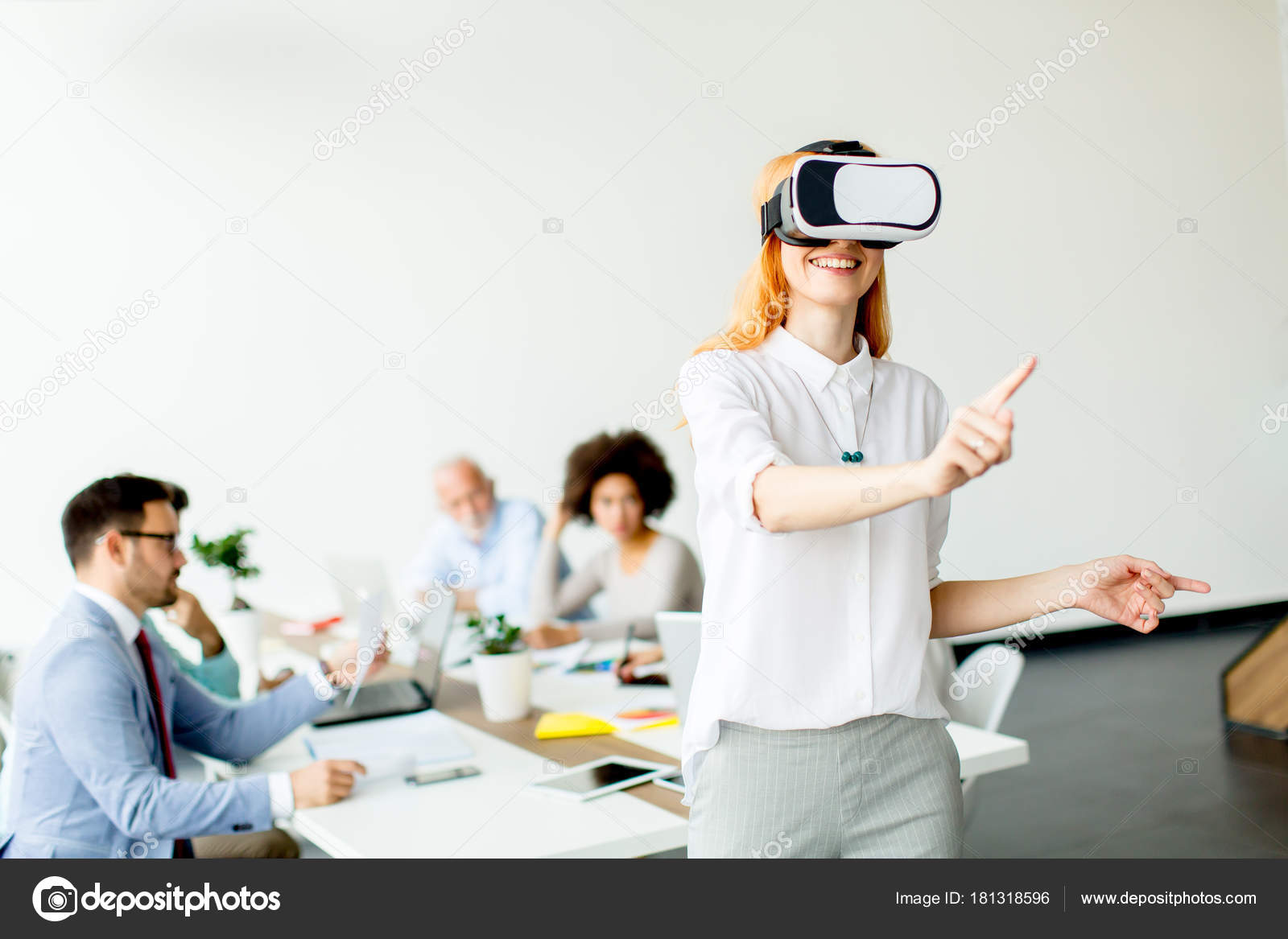 Young Woman Using Virtual Reality Simulator Meeting Office — Stock Photo © boggy22 181318596