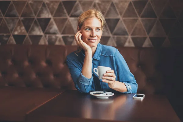 Mujer joven y bonita sentada en el café — Foto de Stock