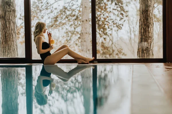 Hübsche junge Frau entspannt sich am Pool — Stockfoto