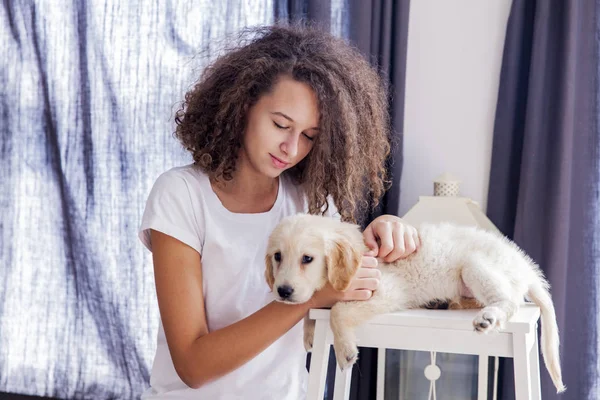 Teenager girl with a small golden retriever — Stock Photo, Image