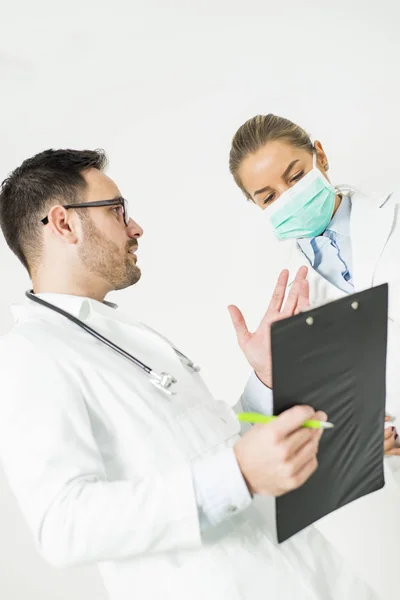 Young doctors with medical file in the hospital