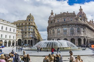 GENOA, ITALY - MARCH 9, 2018: Unidentified people on the Piazza de Ferrari in Genoa, Italy. Piazza De Ferrari is the main square of Genoa. clipart