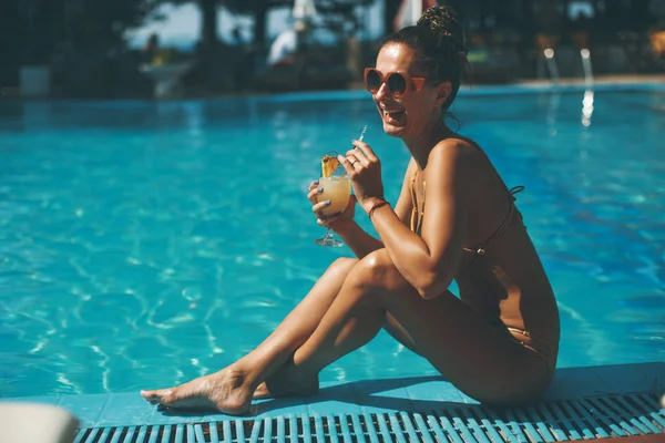 年轻漂亮的女人的游泳池与鸡尾酒 — 图库照片