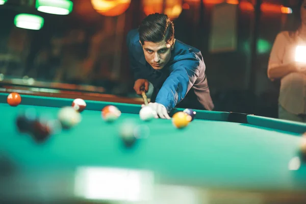Young man playing pool in the bar