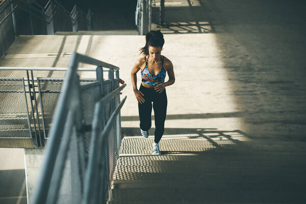 Young woman running alone up stairs  outdoor