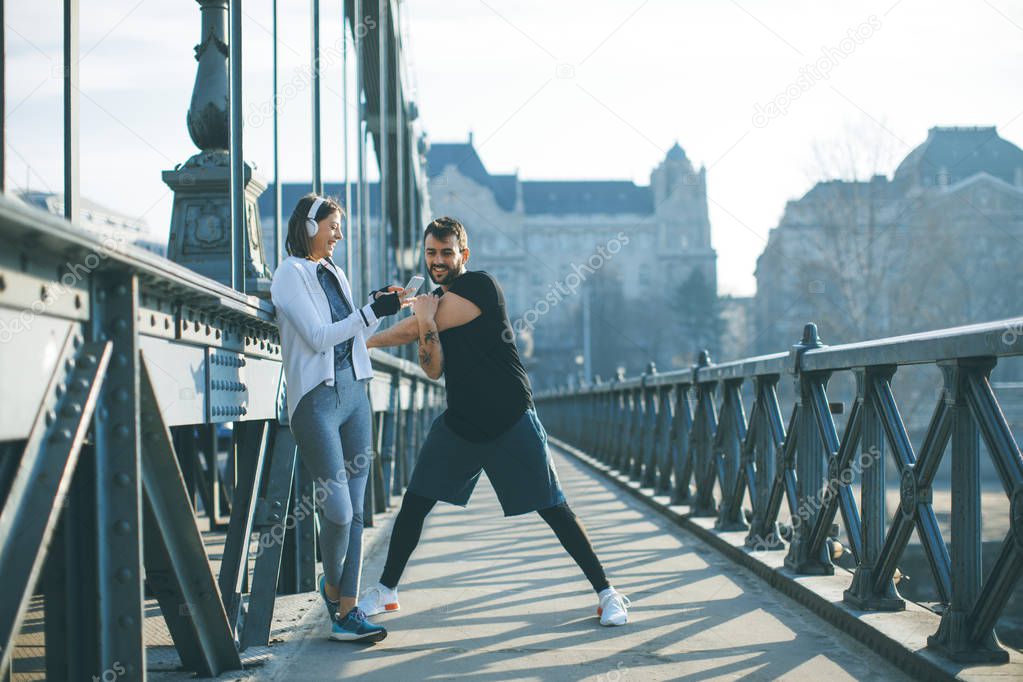 Young handsome couple have training in urban enviroment at sunny day