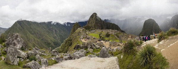 MACHU PICCHU, PERU, JANUARY 3, 2018: Unidentified people at remains of ancient Inca citadel in Machu Picchu, Peru. Almost 2500 tourists visit Machu Picchu every day.