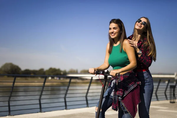 Pretty Young Female Friends Riding Electric Scooter Street Sunny Day — Stock Photo, Image