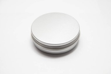 Lip balm in the round metallic tins isolated on the white background clipart