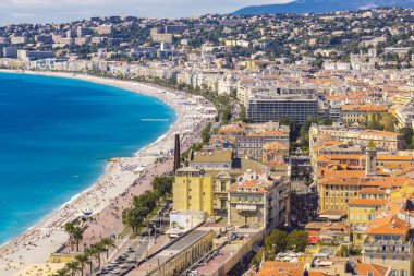 Nice, Fransa - 6 Ekim 2019: Plajda kimliği belirsiz insanlar ve Nice, Fransa 'daki Fransız Riviera' sında gezinti güvertesi. Orada 15 özel ve 20 halk plajı var..