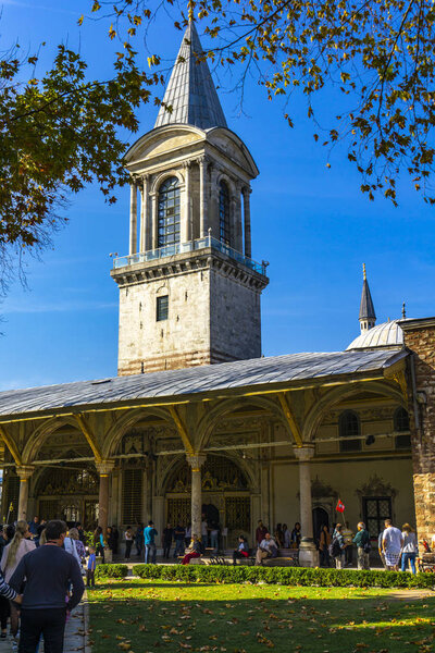 ISTANBUL, TURKEY - NOVEMBER 10, 2019: Unidentified people by Tower of Justice at Topkapi Palace in Istanbul, Turkey. In the 15th century, Topkapi Palace served as the main residence of the Ottoman sultans