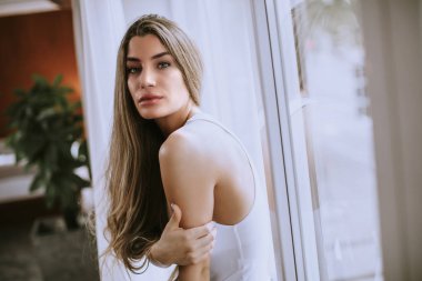 Odanın penceresinde tarafından duran genç ve güzel kadın