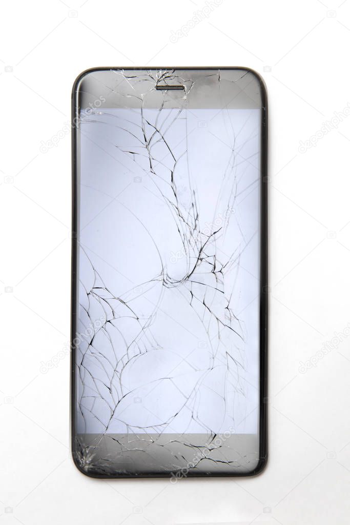 Top view at cracked broken mobile phone screen glass, isolated on the white background