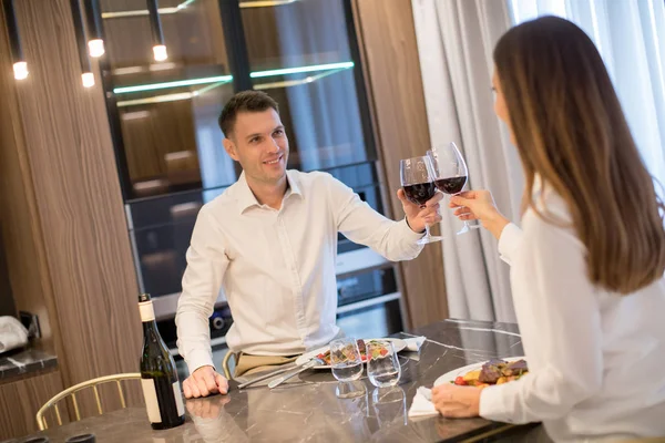 Sweet young couple having a romantic dinner at luxury kitchen