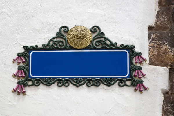 Blank empty blue street sign on a plastered wall with copy space