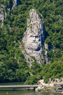 DUBOVA, ROMANIA - MAY 8, 2018: Rock sculpture of Decebalus in Danube gorge, near Dubova, Romania. Sculpture of Decebalus, the last king of Dacia, was made in 1994.
