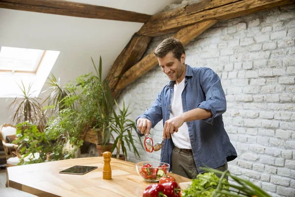 Young man preparing food in the rustic kitchen