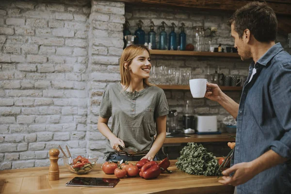 Mujer Joven Cocinando Mientras Hombre Bebe Café Cocina Rústica — Foto de Stock