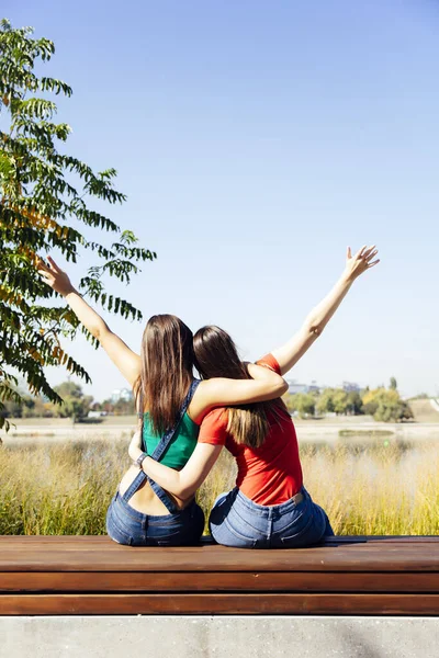 Two Best Female Friends Embracing Together While Sitting Outdoors — Stock Photo, Image