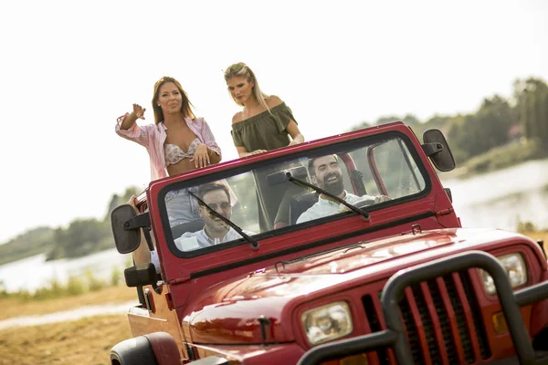 Group of happy young people enjoying road trip