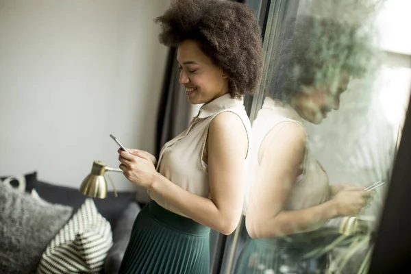 Pretty Young Woman Curly Hair Using Mobile Phone Window Home — Stock Photo, Image